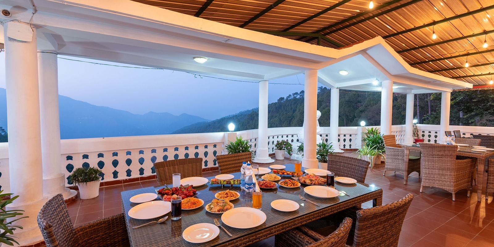 A scenic dining area at DLS Tehri Club Resort with a breathtaking view of the mountains.